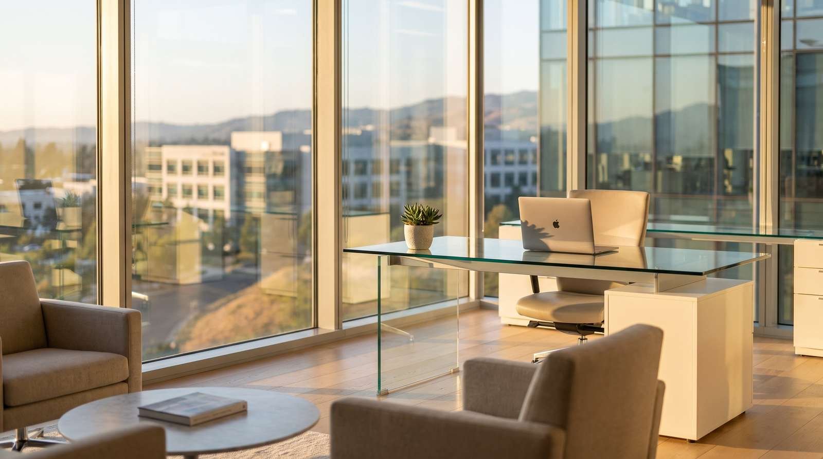 Escritório executivo moderno com grandes janelas de vidro, luz solar quente entrando, uma mesa de vidro com notebook e uma planta, vista de um campus corporativo ao fundo